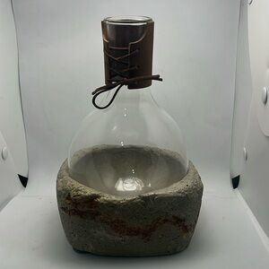 Gorgeous bottle with cement base and leather neck.
